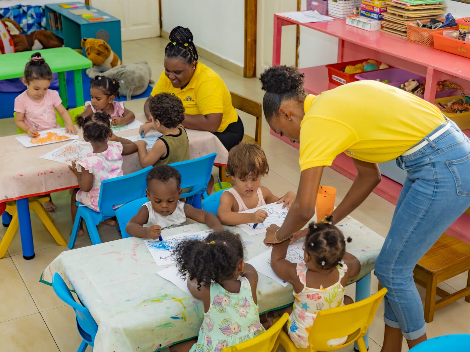A teacher and children working together at a sensory activity table